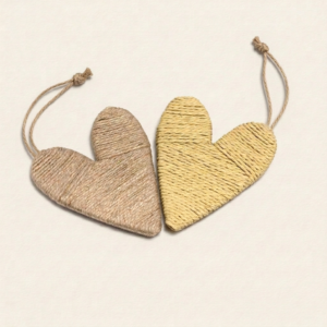 Corazones colgantes de fibras naturales hechos a mano, uno de cáñamo marrón y otro de rafia amarilla, con cordón de yute.